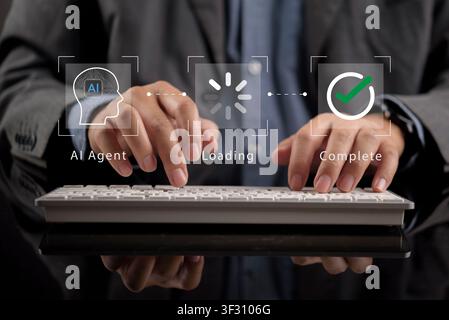 Businessman typing on keyboard with AI Agent interface showing workflow process from loading to complete. Concept of artificial intelligence automatio Stock Photo