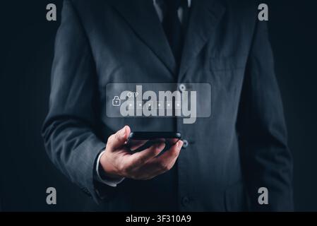 Businessman hand holding smartphone with OTP (One Time Password) verification code on virtual screen. Concept of two-factor authentication, mobile ban Stock Photo