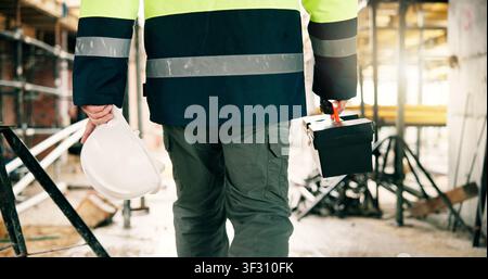 Toolbox, hardhat and construction worker on site with hands for equipment, safety and infrastructure upgrade. Renovation, contractor and person with Stock Photo