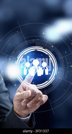 Businessman's hand interacts with a glowing digital interface showing human resources icons, representing recruitment, leadership, and team management Stock Photo