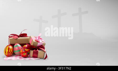 Festive Easter eggs and gift boxes in the foreground with a symbolic background of three crosses on a hill, representing the religious and celebratory Stock Photo