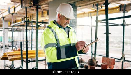Man, inspection and writing on construction site with clipboard, quantity surveyor and verify invoice. Cost manager, mature person and building Stock Photo