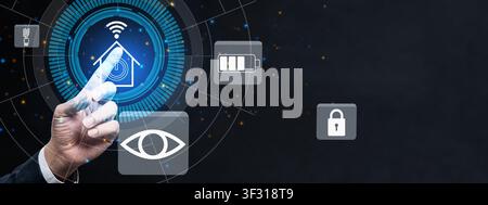 A hand interacts with a futuristic smart home control panel featuring icons for security, lighting, energy, and surveillance against a dark, tech-orie Stock Photo