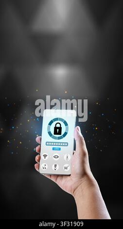 A hand holds a smartphone displaying a digital security interface with a large padlock icon and password field, set against a dark background with glo Stock Photo