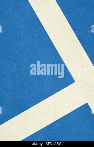 A top-down close-up view of a blue synthetic sports court surface featuring crisp white painted boundary lines and a granular texture Stock Photo