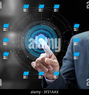 Conceptual image of cloud computing showing a businessman's hand selecting a digital cloud icon with data transfer arrows within a complex network inf Stock Photo