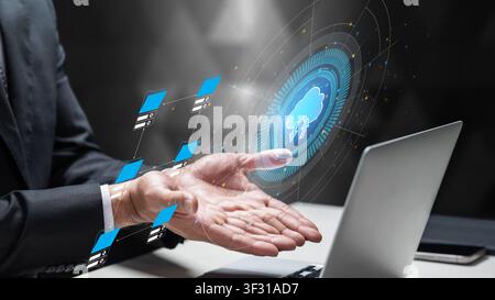Businessman interacts with a futuristic digital cloud interface, representing data storage, networking, and IT infrastructure solutions for modern bus Stock Photo