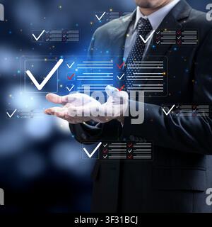 A professional businessman interacts with a futuristic digital interface showing completed checklists, symbolizing task management, quality control, a Stock Photo