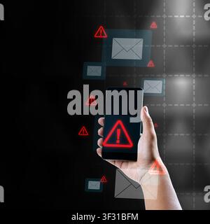 A person holding a smartphone showing a red warning triangle alert, surrounded by floating email icons and warning signs, representing phishing, cyber Stock Photo