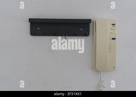 Black key holder shelf and intercom on a white wall Stock Photo