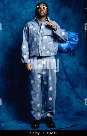 Portrait of Black Man Carrying Shopping Bag for Fashion Campaign Stock Photo