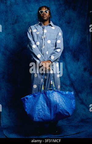 Portrait of Black Man Holding Oversized Shopping Bag for Retail Campaign Stock Photo