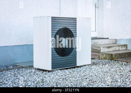 Split heating and cooling pump installed in front of family house Stock Photo