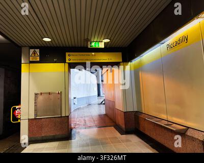 Manchester, UK - May 07, 2026: Empty tiled corridor at Piccadilly station in Manchester with MetroLink signs, exit lights and urban transit details. Stock Photo