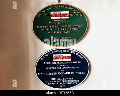 Manchester, UK - May 07, 2026: Two heritage award plaques for Manchester Piccadilly station mounted on a plaster wall at the Fairfield Street entrance Stock Photo