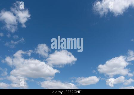 soft overcast cloud cover with pale blue openings, forming a moody vertical sky background with copy space. Stock Photo