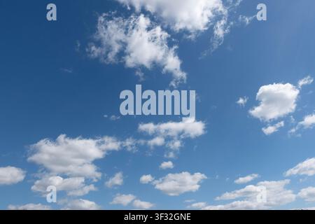 soft overcast cloud cover with pale blue openings, forming a moody vertical sky background with copy space. Stock Photo