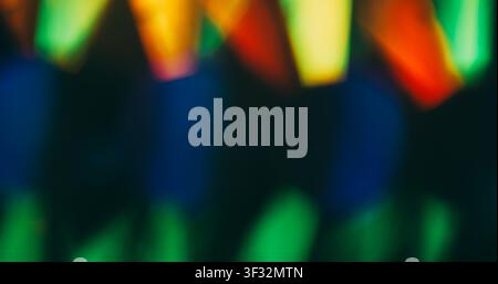 Color flare. Blur light rays. Defocused green blue red multicolor shine lens flare glare gleam glow on dark black abstract background. Stock Photo