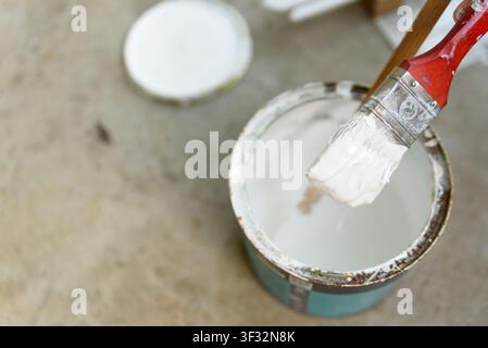 Open white paint can, top-down view. High-resolution stock photo showing a standard cylindrical metal paint container with its lid removed, revealing Stock Photo