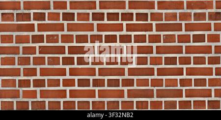 A seamless texture of an decorative red brick wall featuring alternating horizontal and vertical brick placement. Stock Photo