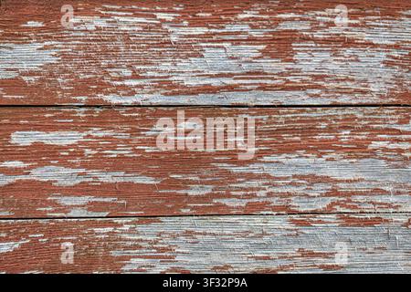 Closeup aged timber boards showing cracked paint and rough grain Stock Photo