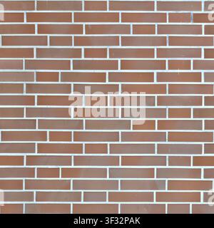 A perfectly structured brown brick wall with neat white grout lines in a classic running bond layout, ideal for modern architectural design. Stock Photo