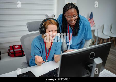 Two female nurses providing support and assistance in a medical call center Stock Photo