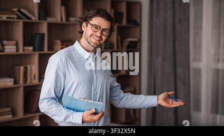 Smiling Caucasian Male Professional Presenting Ideas In Office, Business Concept Stock Photo