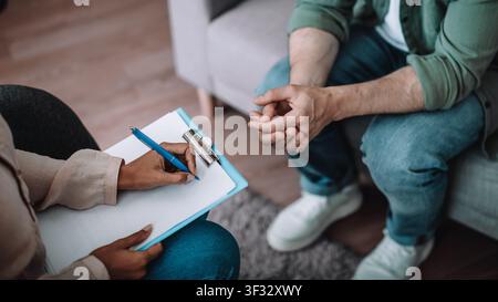 Therapist Taking Notes During Patient Consultation, Office, Counseling Concept Stock Photo