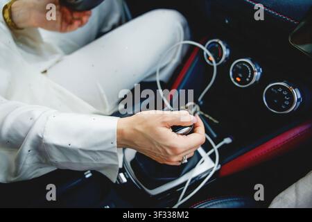 close up of woman hand shifting gears in luxury car Stock Photo