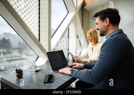 Professional people working using laptops in modern office Stock Photo