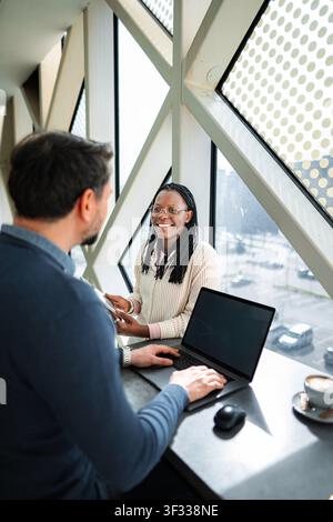 Modern business colleagues collaborating in bright office workspace Stock Photo