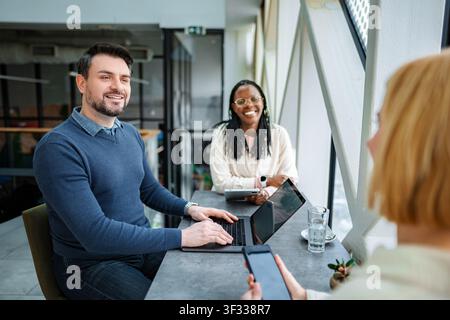 Diverse startup team collaborating during informal business meeting Stock Photo