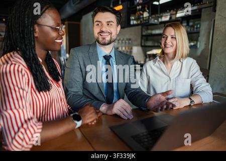 Business professionals collaborating at casual meeting discussing ideas Stock Photo