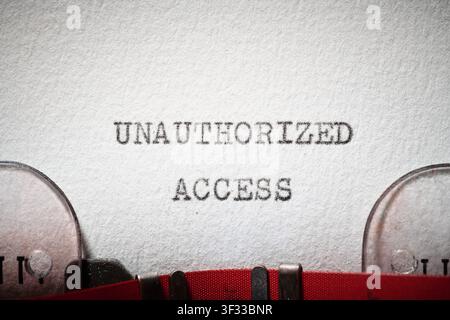Unauthorized access text written with a typewriter. The system displays a security failure warning. Stock Photo