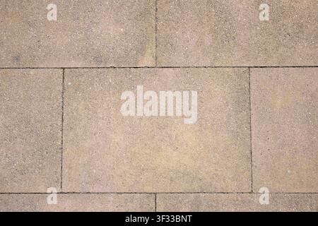 Background created from a close-up of a rectangular stone pavement. Strong and resistant tile floor. Stock Photo