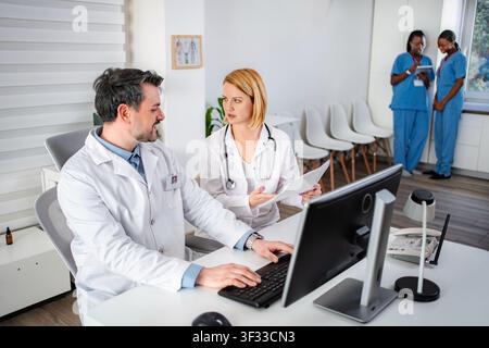 Doctors and nurses collaborating in hospital office Stock Photo