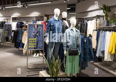 Modern apparel shop interior with denim display. London, UK, 25 February 2024 Stock Photo