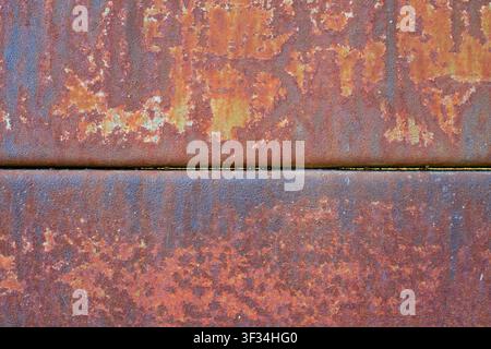 Two rusted metal plates texture. Weathered iron surface and vintage corrosion material background. Oxidized steel sheet with old peeling paint and ora Stock Photo