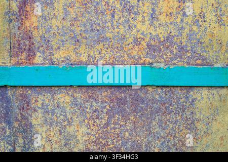 Rusted metal plate texture with green horizontal metal stripe. Weathered iron surface and vintage corrosion material background. Oxidized steel sheet Stock Photo