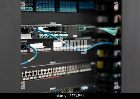 Network Server Rack with Patch Panels and Fiber Optic Cabling in Data Center Stock Photo
