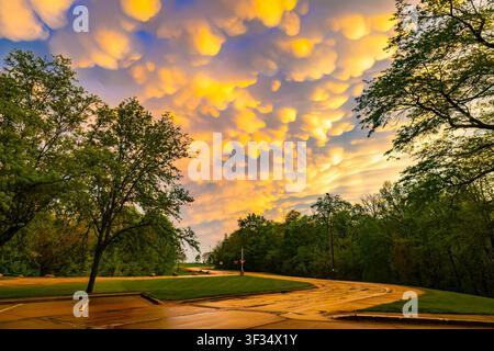 Dramatic mammatus clouds glowing at sunset after a passing storm in the evening sky Stock Photo