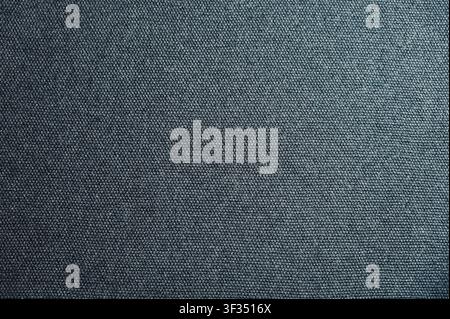 Macro full frame detail of dark grey or black denim textile showing diagonal twill weave pattern. High quality seamless style background concept for fashion, apparel design, casual wear, or background wallpaper. Stock Photo