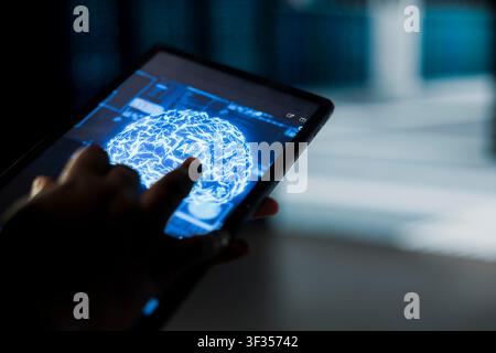 Close up of data center computer scientist using AI on tablet to troubleshoot backend operations gear. Server hub worker running deep learning software development program, resolving system crashes Stock Photo