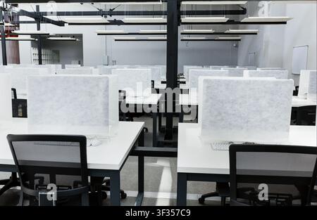 Wrapped in cover computers on places for workers in co-working Stock Photo