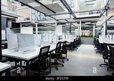 Big empty rental office with modern computers under cover Stock Photo