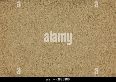 Brown sugar granules creating a sweet, textured background Stock Photo