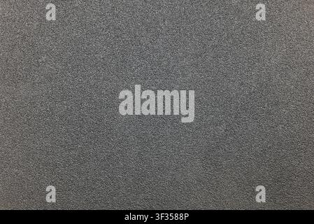 Gray asphalt felt or sandpaper surface showing a rough, abrasive texture Stock Photo