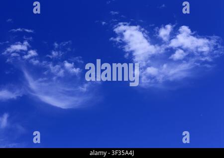 Cloudscape. Concepts - environment. Cirrus, cumulus and cirrostratus clouds with a deep blue sky. Backgrounds. Copy space. Stock Photo