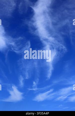 Cloudscape. Concepts - environment. Cirrus and cirrostratus clouds with a deep blue sky. Backgrounds. Copy space. Stock Photo